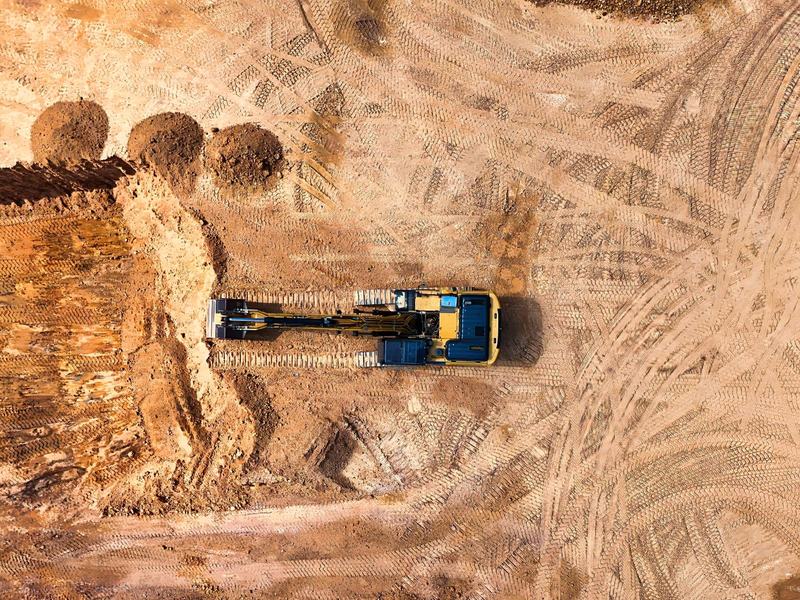Aerial view of an excavator cutting a formation on an earthworks site