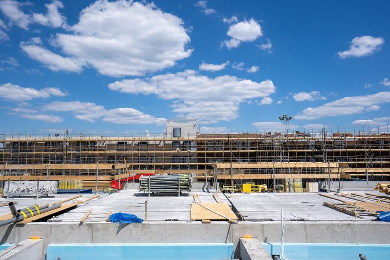 Concrete frame with edge protection and scaffolding on a residential block under construction