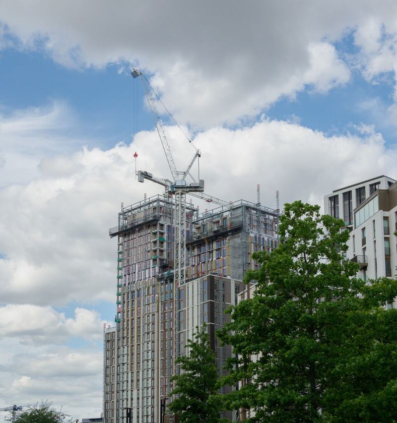 Residential tower under construction in London with a luffing tower crane