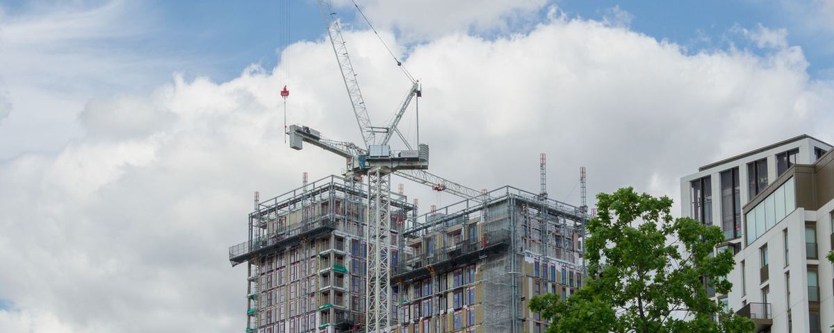 Residential tower under construction in London with a luffing tower crane