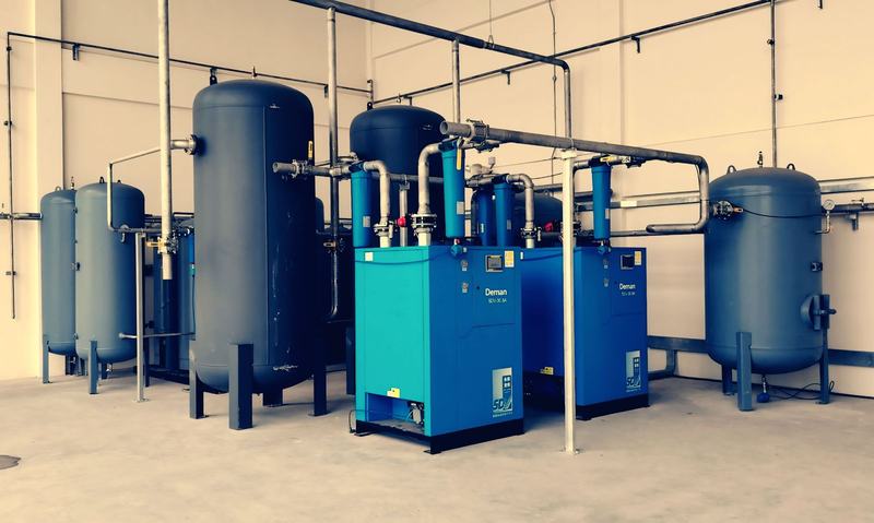 Compressed air plant and pipework inside an industrial building