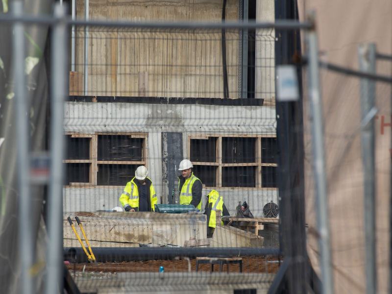 Site team in hard hats and hi-vis working on a reinforced concrete structure
