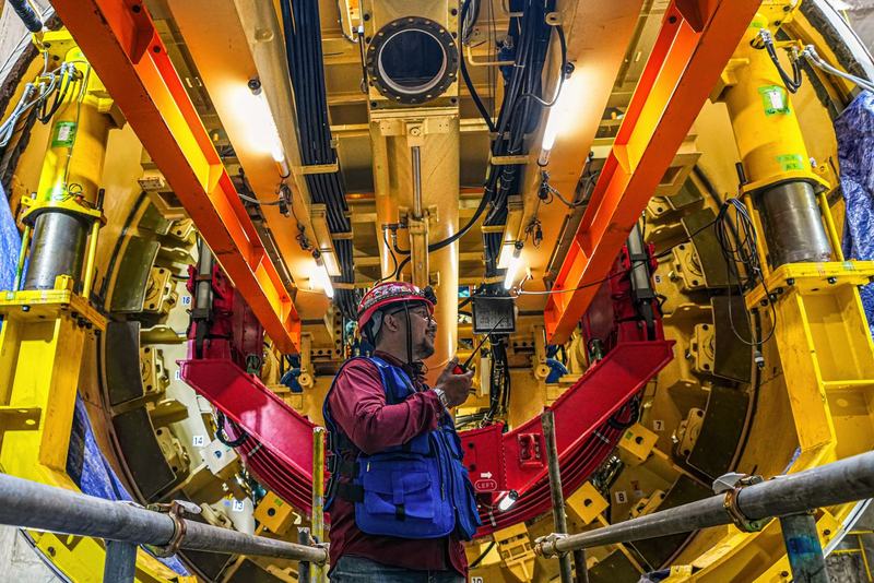 Engineer in PPE inside a tunnel boring machine